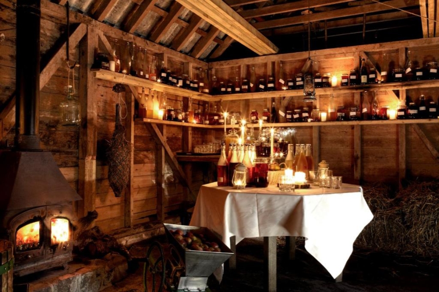 Cozy, rustic room with a candlelit table, designed for enjoying wines at Bovey Castle, United Kingdom.