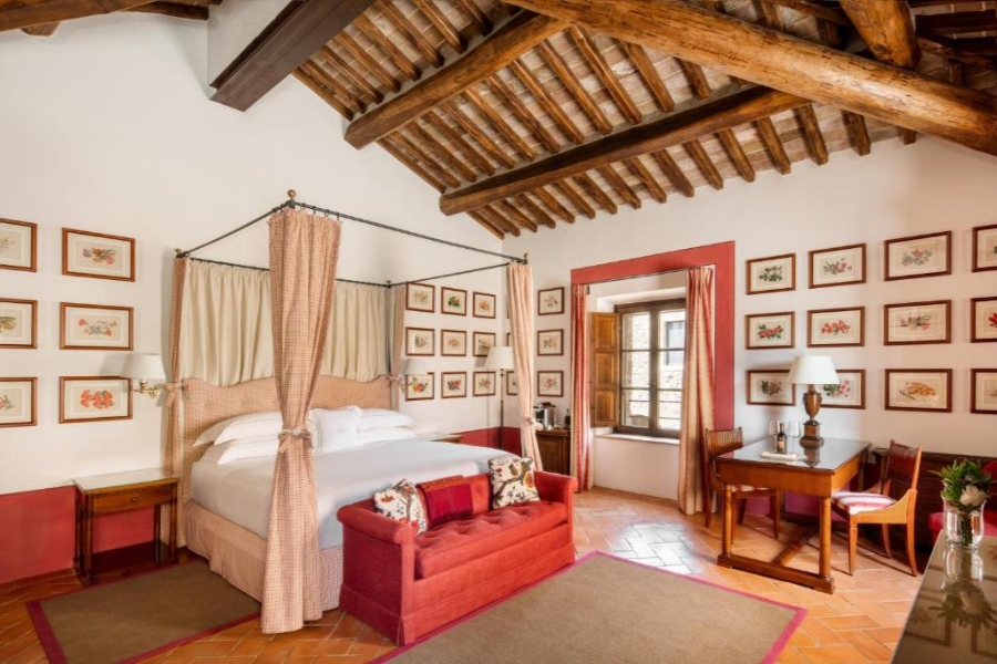 Elegant bedroom with a four-poster bed and decorative wall art, showcasing a warm and welcoming design.