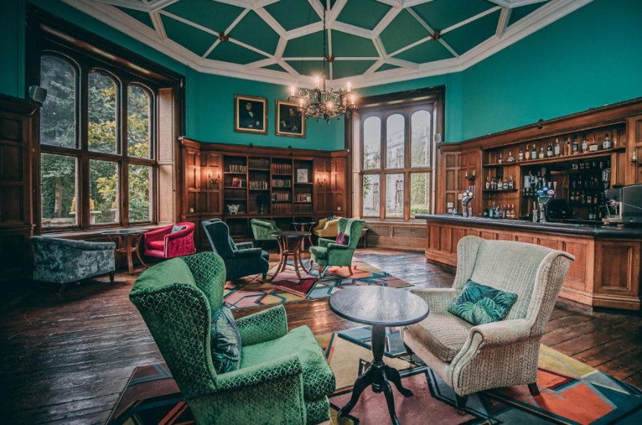 Interior view of the library at Ruthin Castle Hotel & Spa, featuring elegant furnishings and a cozy atmosphere.