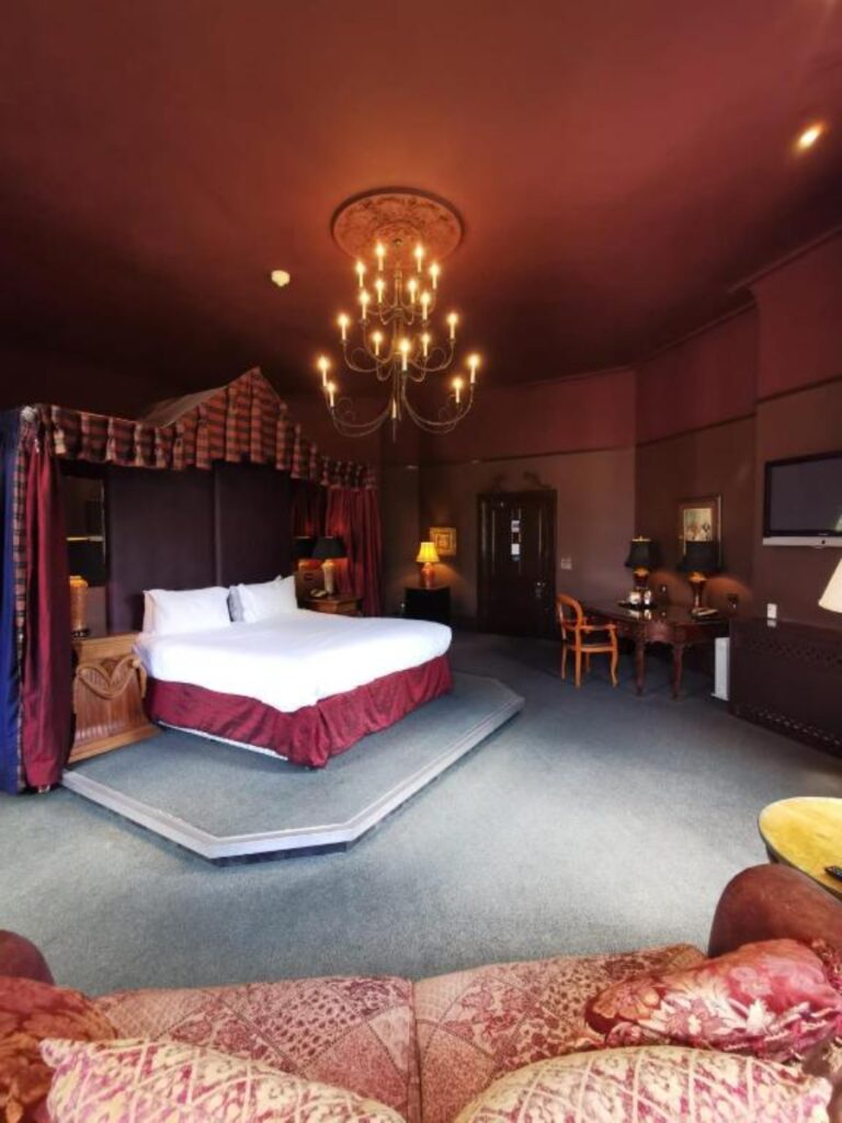 Luxurious room at Ruthin Castle Hotel & Spa, featuring elegant decor and a cozy atmosphere in London, England.