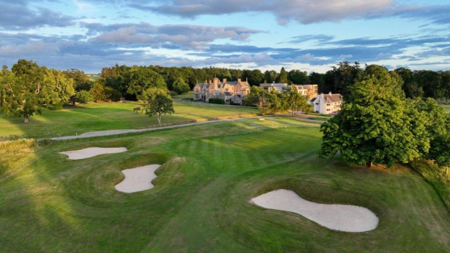 Scenic view of Schloss Roxburghe Golf Resort, showcasing lush fairways and the historic castle in the background.