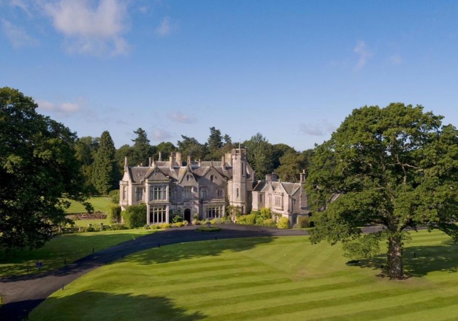 Scenic landscape of Schloss Roxburghe Golf Resort, with vibrant green grass enveloping the estate.
